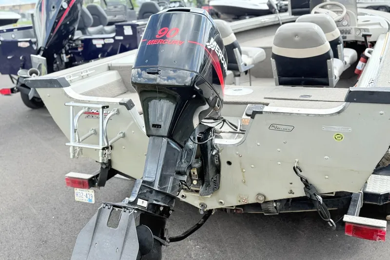 Slide: The Image of 2000 Tracker Targa 17 boat with Mercury 90 outboard motor, parked on a trailer. - 2