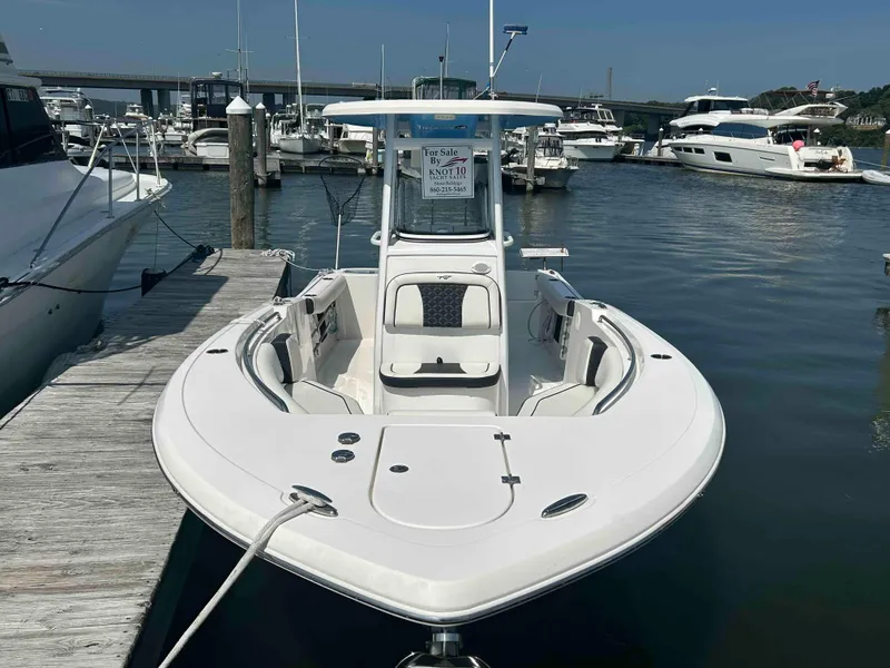 Slide: The Image of 2021 Tidewater 232 CC Adventure boat docked at marina, for sale sign visible. - 3