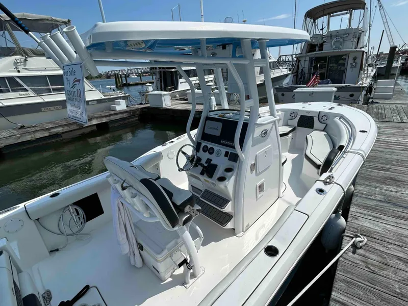 Slide: The Image of 2021 Tidewater 232 CC Adventure boat docked, featuring a modern helm and seating area. - 5