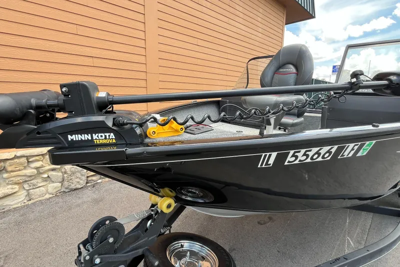 Slide: The Image of 2023 Tracker Pro Guide V-175 Combo with Minn Kota Terrova motor, parked outdoors. - 4