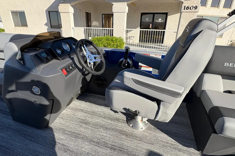 Slide: The Image of 2026 Bennington 21 SSR boat interior with steering wheel and captain's chair. - 12