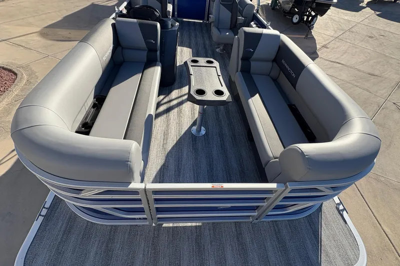 Slide: The Image of 2026 Bennington 21 SSR pontoon boat with gray seating and central table on deck. - 7