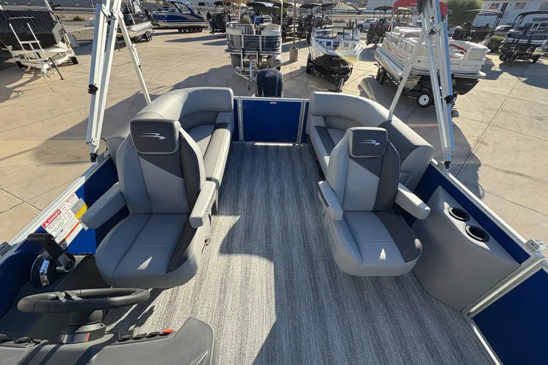 Slide: The Image of 2026 Bennington 21 SSR pontoon boat interior with gray seating and steering console. - 9