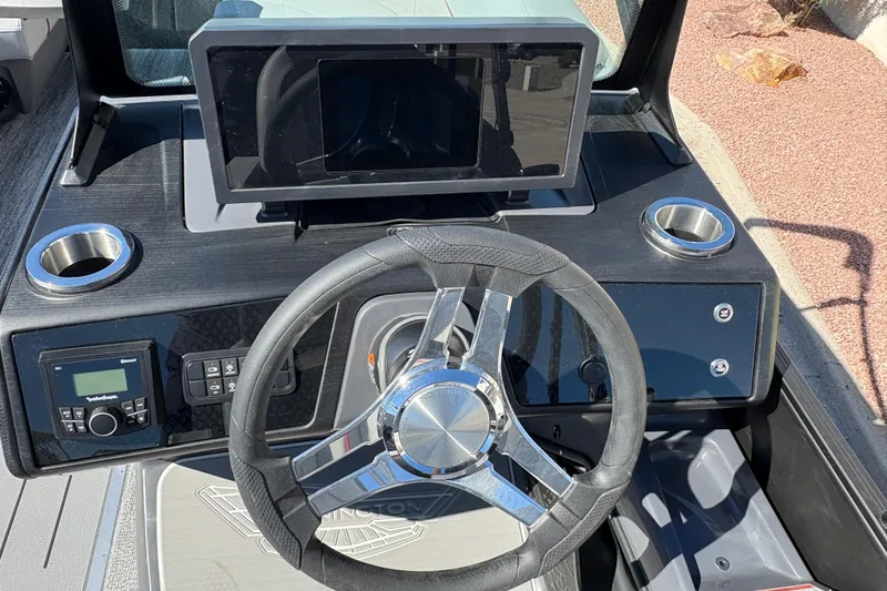 Slide: The Image of 2026 Bennington 22 MFB boat dashboard with steering wheel and control panel. - 12