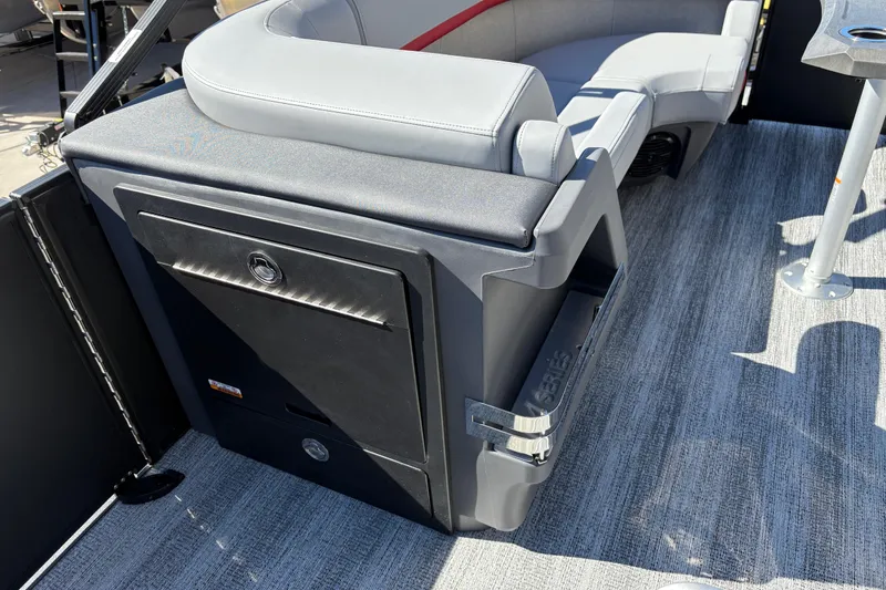 Slide: The Image of 2026 Bennington 22 MFB boat interior with gray seating and storage compartment. - 14