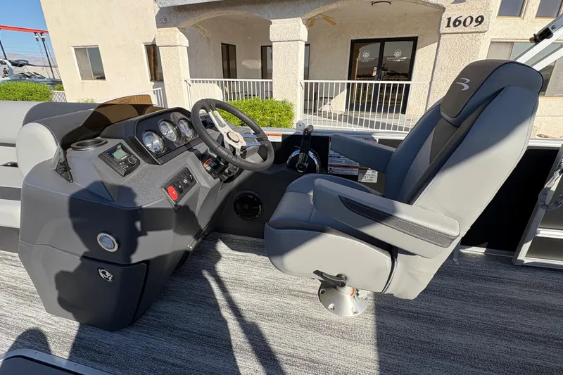 Slide: The Image of 2026 Bennington 21 SSB boat interior with steering console and captain's chair. - 8