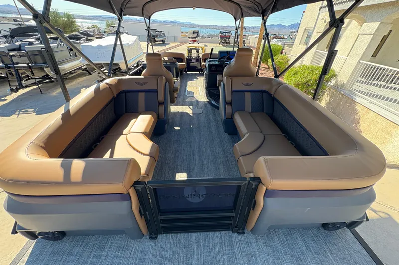 Slide: The Image of 2026 Bennington 24 MFB pontoon boat with luxurious brown seating and spacious deck layout. - 7