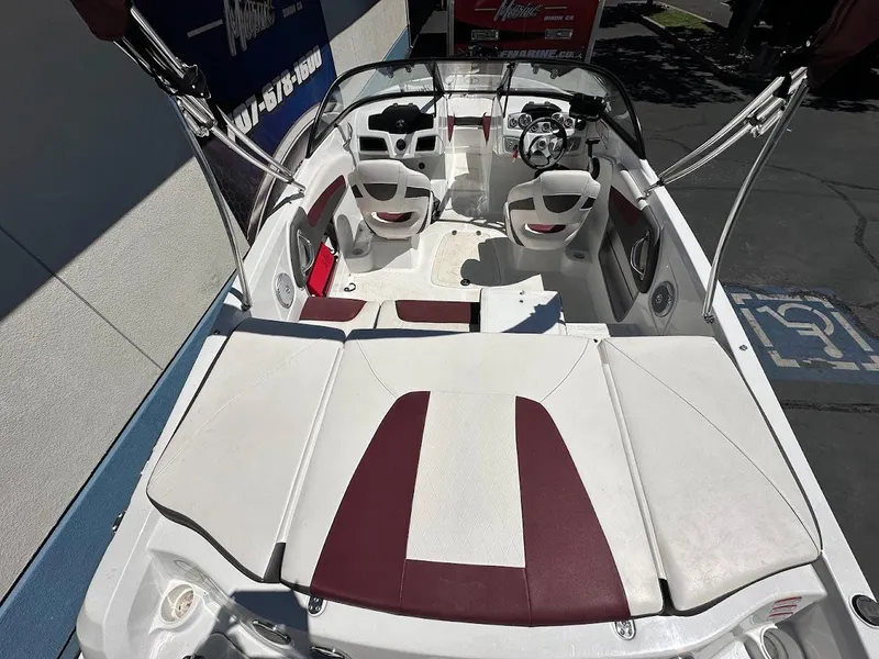 Slide: The Image of 2018 Tahoe 500 TF boat interior with white and maroon seating, steering wheel, and controls. - 11
