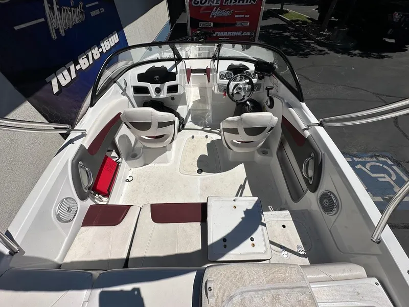 Slide: The Image of 2018 Tahoe 500 TF boat interior with seating and steering wheel, parked outdoors. - 13