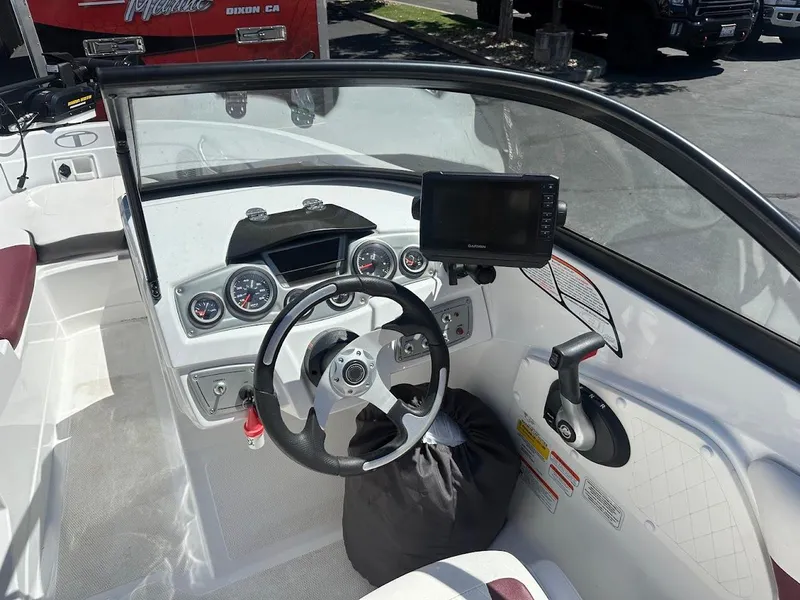 Slide: The Image of Interior of a 2018 Tahoe 500 TF boat with steering wheel and dashboard controls. - 21