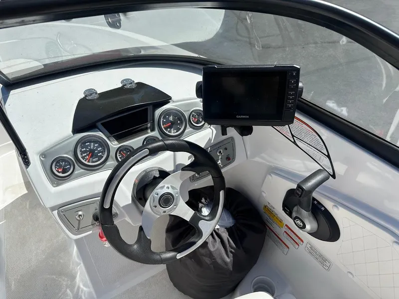 Slide: The Image of 2018 Tahoe 500 TF boat dashboard with steering wheel, gauges, and Garmin display. - 22