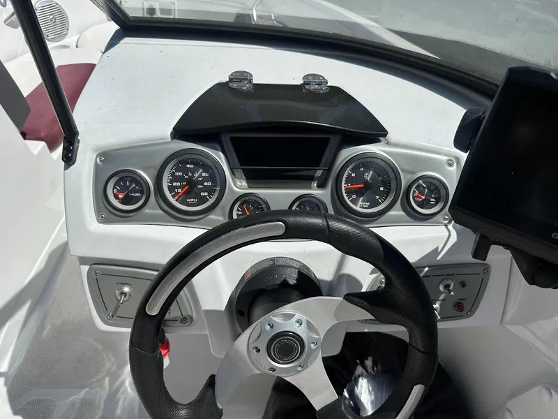 Slide: The Image of Dashboard of a 2018 Tahoe 500 TF boat with steering wheel and gauges. - 23
