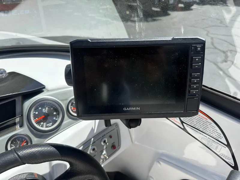 Slide: The Image of Garmin GPS on 2018 Tahoe 500 TF boat dashboard with steering wheel and gauges. - 24