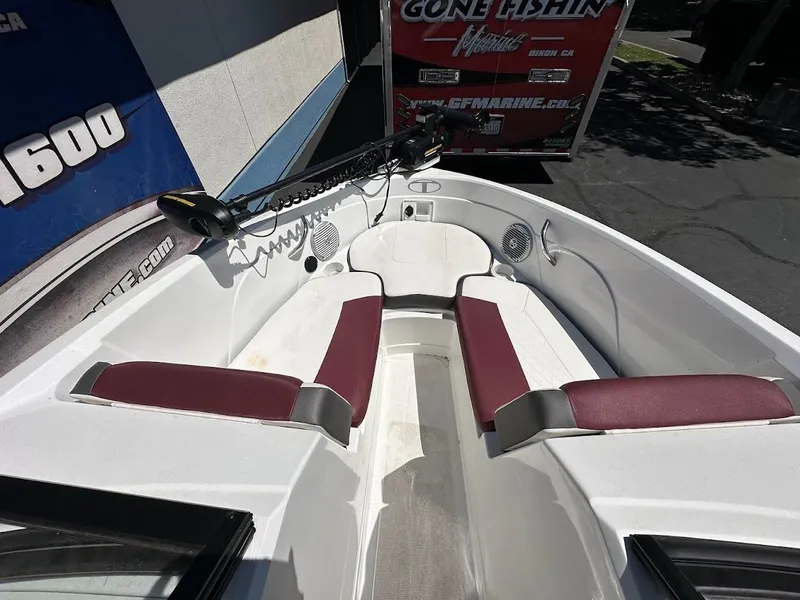 Slide: The Image of 2018 Tahoe 500 TF boat interior with maroon and white seating, trolling motor, and speakers. - 25