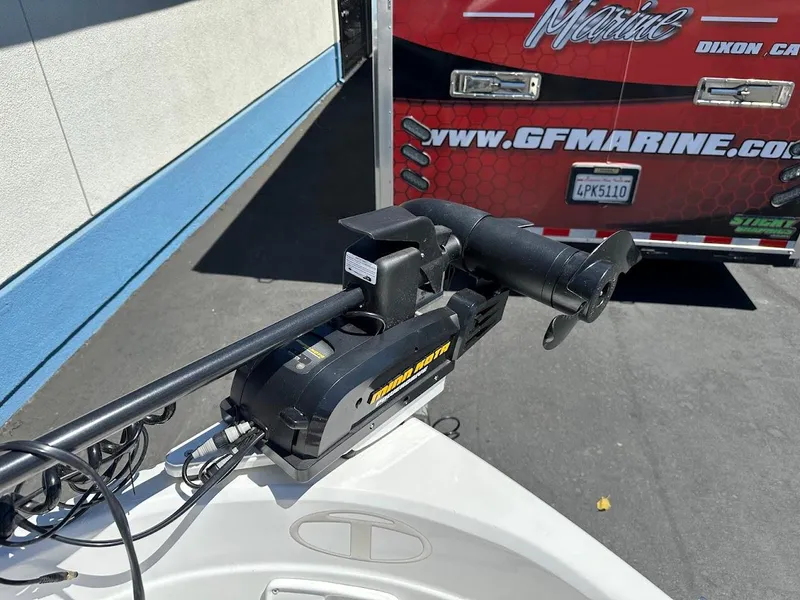 Slide: The Image of Trolling motor on 2018 Tahoe 500 TF boat, parked near GF Marine trailer. - 28