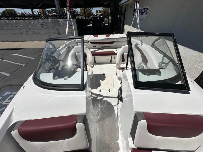 Slide: The Image of 2018 Tahoe 500 TF boat interior with red and white seating, open windshield, and steering console. - 29