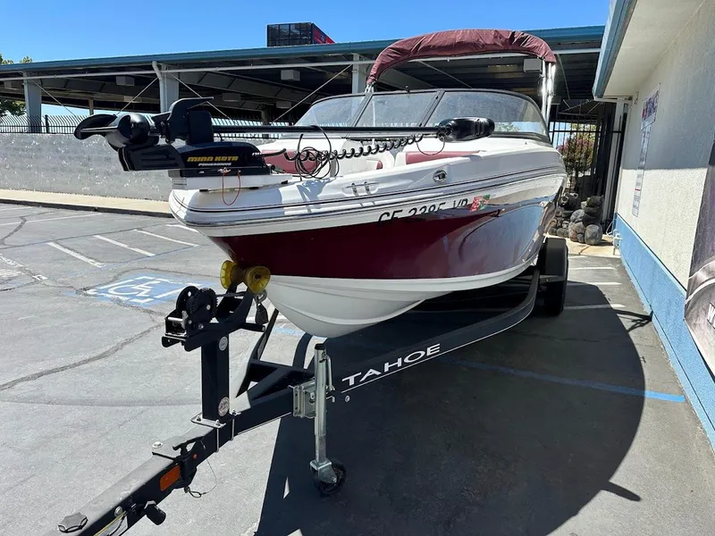 Slide: The Image of 2018 Tahoe 500 TF boat on trailer in parking lot, featuring maroon and white design. - 3