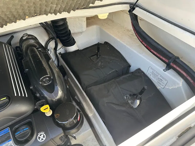 Slide: The Image of Engine compartment of a 2018 Tahoe 500 TF boat, showing engine and components. - 33