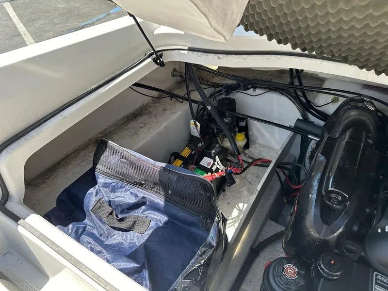 Slide: The Image of Open engine compartment of 2018 Tahoe 500 TF boat with visible battery and wiring. - 34