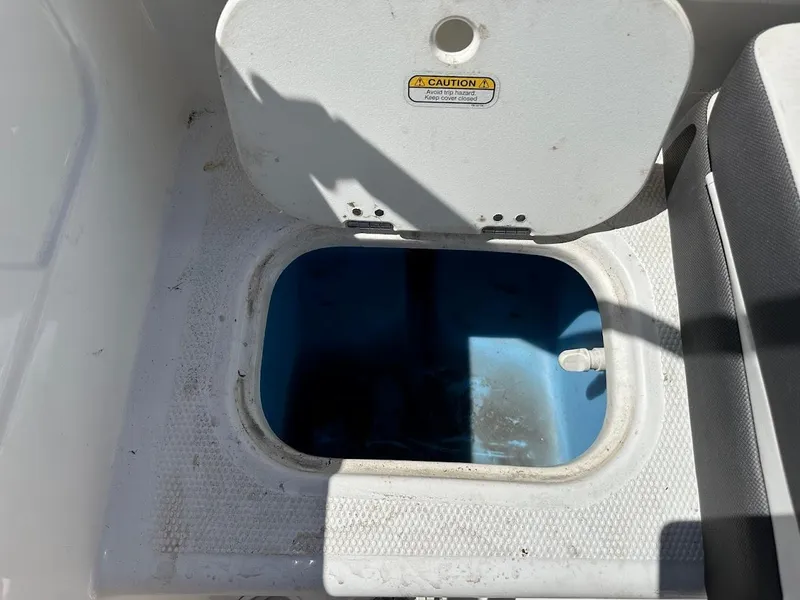 Slide: The Image of Open storage compartment on a 2018 Tahoe 500 TF boat. - 37