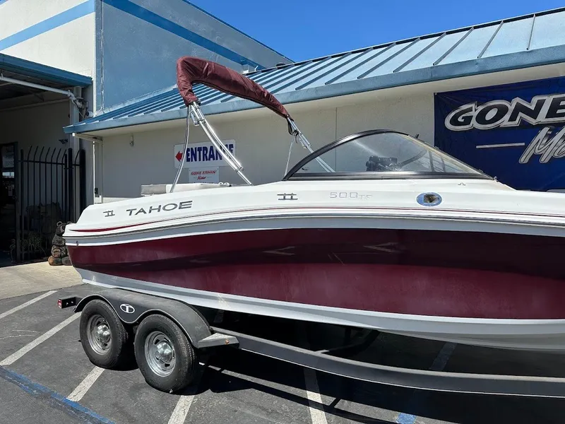 Slide: The Image of 2018 Tahoe 500 TF boat on trailer outside a building under clear blue sky. - 6