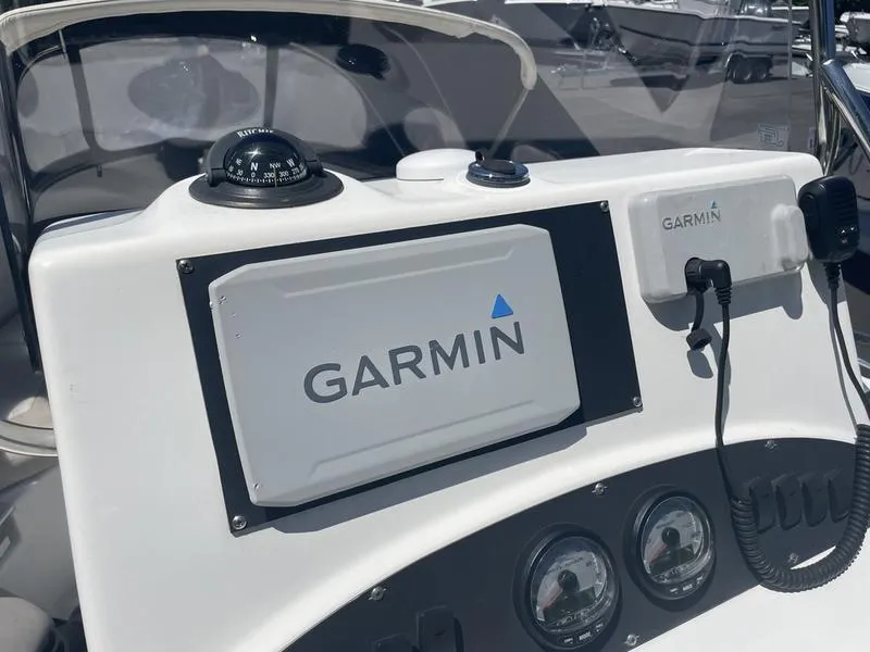 Slide: The Image of 2006 Boston Whaler 210 Outrage dashboard with Garmin navigation system and compass. - 11