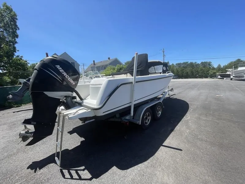 Slide: The Image of 2006 Boston Whaler 210 Outrage boat on trailer with Mercury outboard motor. - 6