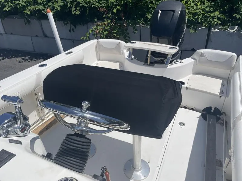 Slide: The Image of 2006 Boston Whaler 210 Outrage boat interior with steering wheel and covered console. - 7