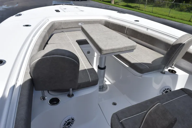 Slide: The Image of 2026 Sea Hunt Gamefish 28 Forward Seating with gray cushioned seats and table. - 12