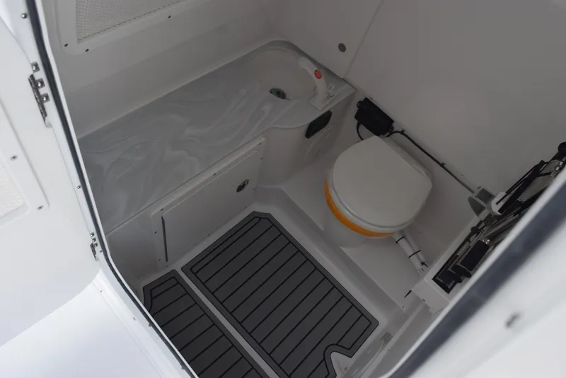 Slide: The Image of 2026 Sea Hunt Gamefish 28 boat interior with toilet and storage area. - 16