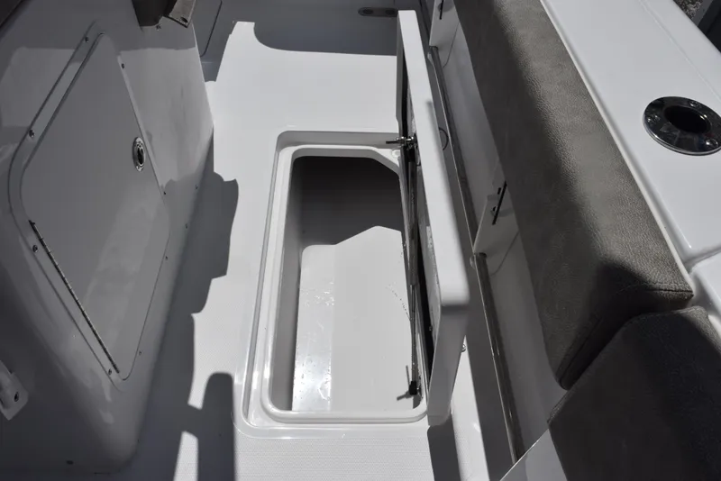 Slide: The Image of 2026 Sea Hunt Gamefish 28 Forward Seating storage compartment with open hatch and cushioned seating. - 20