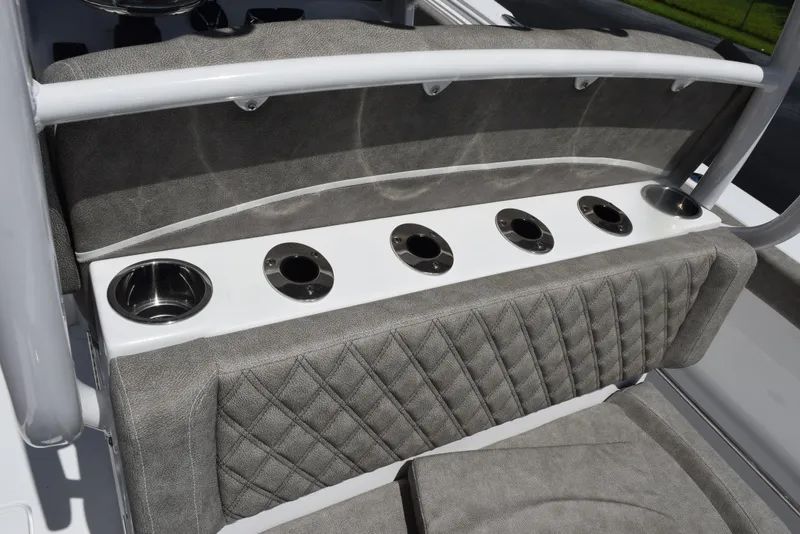 Slide: The Image of 2026 Sea Hunt Gamefish 28 boat seating with integrated cup holders and quilted upholstery. - 28