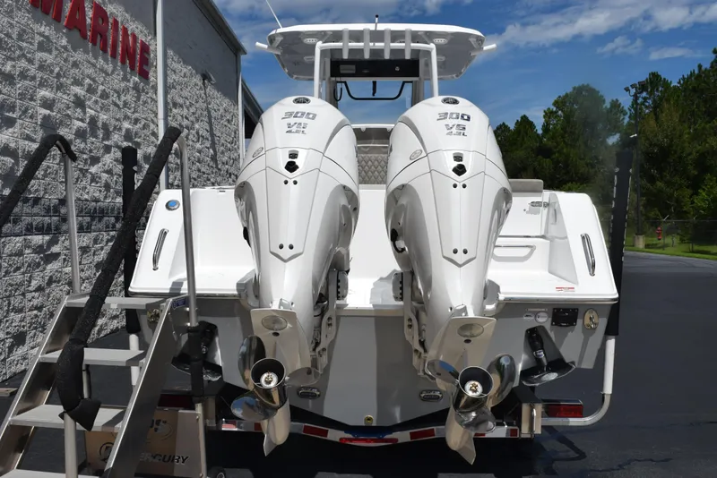 Slide: The Image of 2026 Sea Hunt Gamefish 28 with twin 300 V6 engines, parked outdoors. - 4