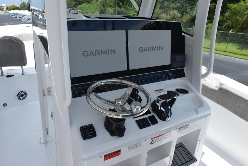 Slide: The Image of 2026 Sea Hunt Gamefish 28 helm with dual Garmin displays and steering wheel. - 9