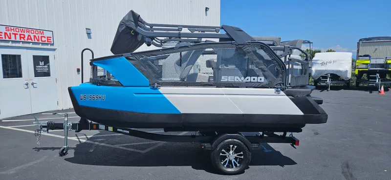 Slide: The Image of 2023 Sea-Doo Switch Sport Compact on trailer outside showroom entrance. - 14