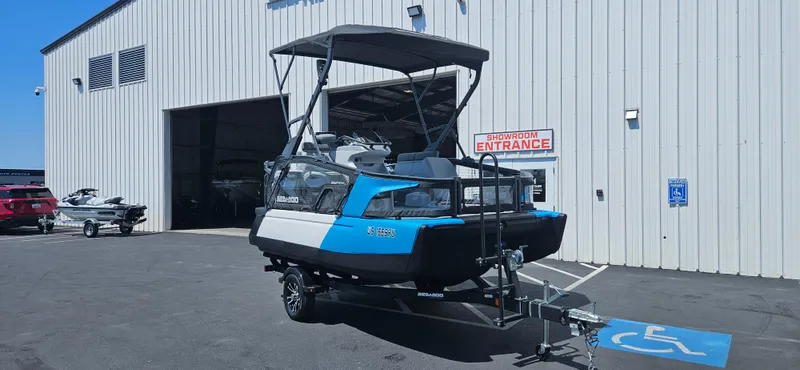 Slide: The Image of 2023 Sea-Doo Switch Sport Compact parked outside a showroom entrance. - 5