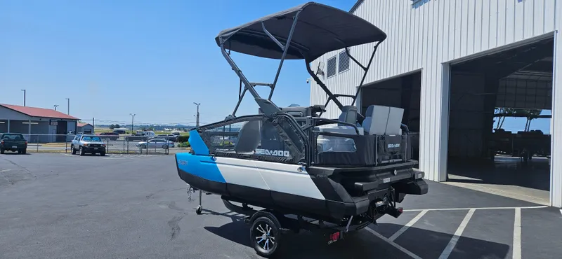 Slide: The Image of 2023 Sea-Doo Switch Sport Compact boat parked outside a warehouse. - 7