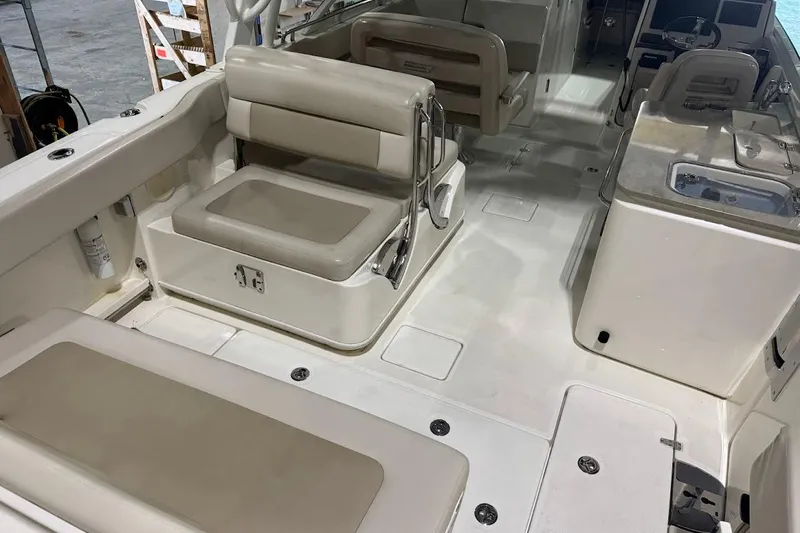 Slide: The Image of 2022 Boston Whaler 320 Vantage interior with seating and helm, showcasing spacious design. - 10