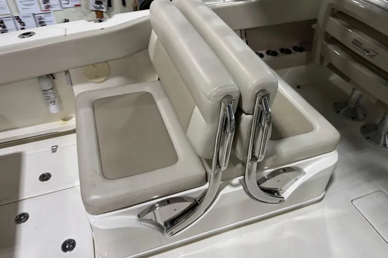 Slide: The Image of 2022 Boston Whaler 320 Vantage boat seating with chrome accents and beige upholstery. - 12