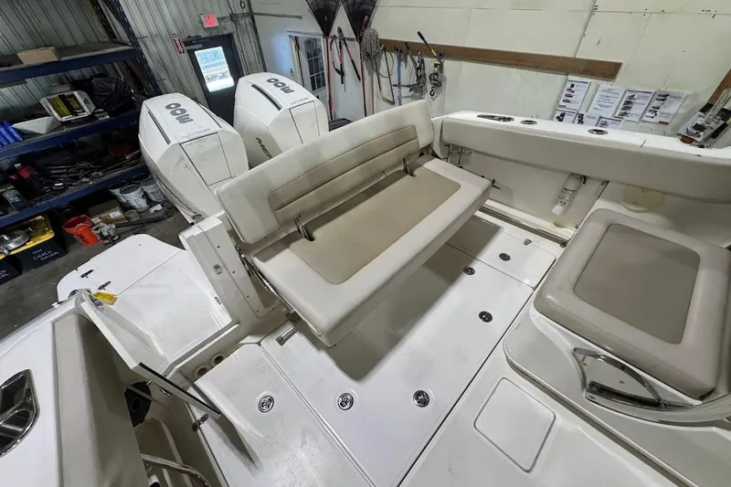 Slide: The Image of 2022 Boston Whaler 320 Vantage boat interior with seating and dual outboard engines. - 14