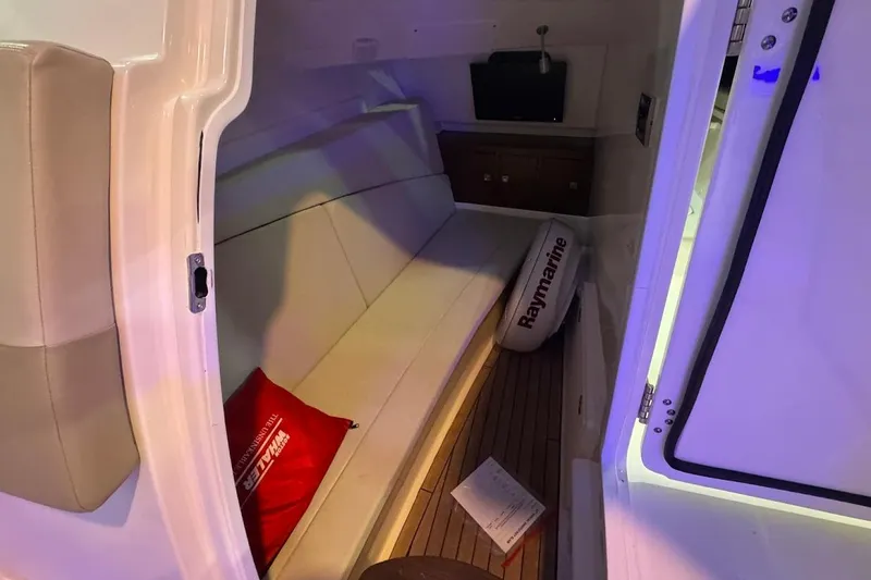 Slide: The Image of Interior cabin of 2022 Boston Whaler 320 Vantage, featuring seating and storage. - 22