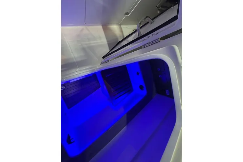 Slide: The Image of Interior of 2022 Boston Whaler 320 Vantage with blue ambient lighting. - 23