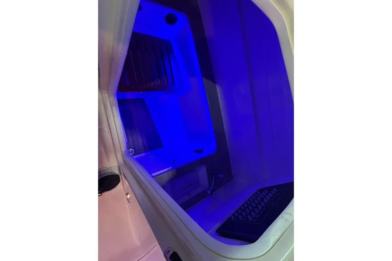 Slide: The Image of Interior of 2022 Boston Whaler 320 Vantage boat with blue ambient lighting. - 24