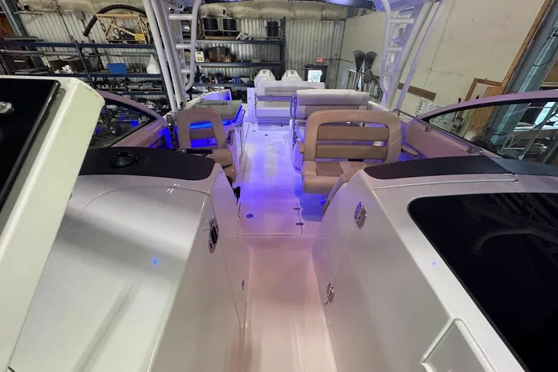 Slide: The Image of Interior view of 2022 Boston Whaler 320 Vantage boat with seating and blue lighting. - 28