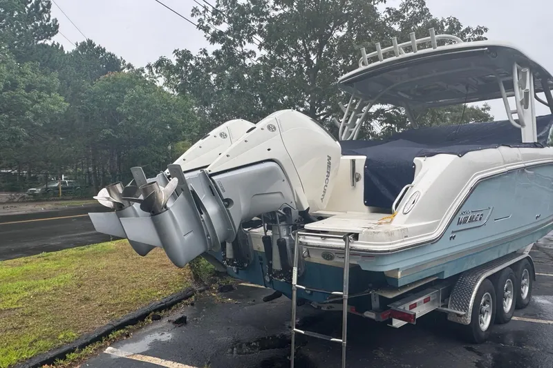 Slide: The Image of 2022 Boston Whaler 320 Vantage boat on trailer with dual Mercury outboard engines. - 3