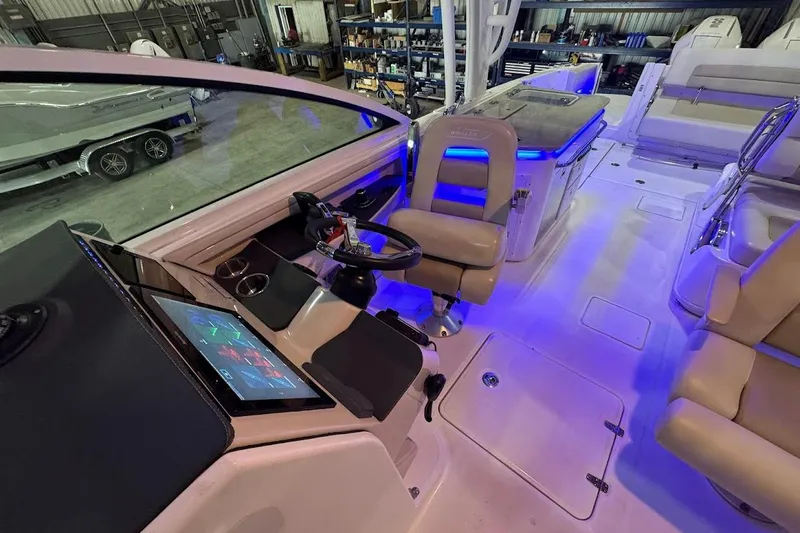 Slide: The Image of 2022 Boston Whaler 320 Vantage boat interior with modern dashboard and seating. - 30