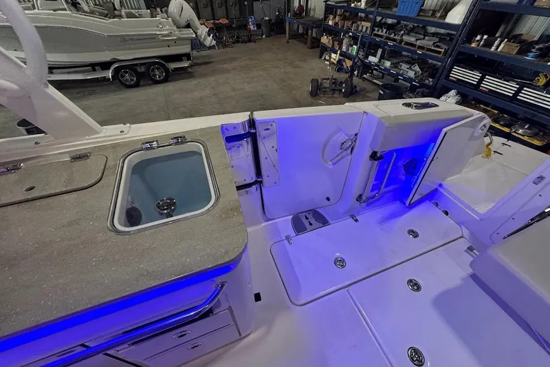 Slide: The Image of 2022 Boston Whaler 320 Vantage interior with blue LED lighting and sleek design. - 34