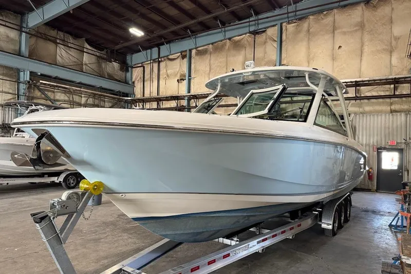 Slide: The Image of 2022 Boston Whaler 320 Vantage boat on trailer in warehouse setting. - 35