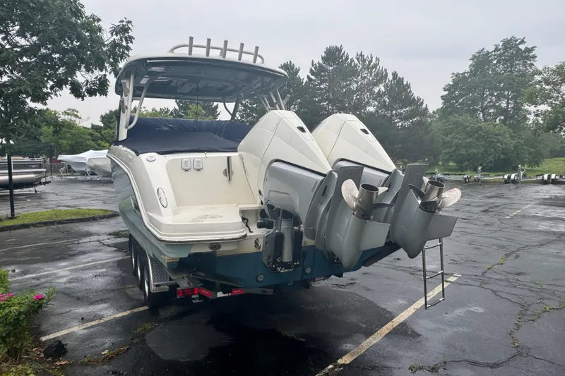Slide: The Image of 2022 Boston Whaler 320 Vantage boat with dual outboard engines on a trailer. - 4