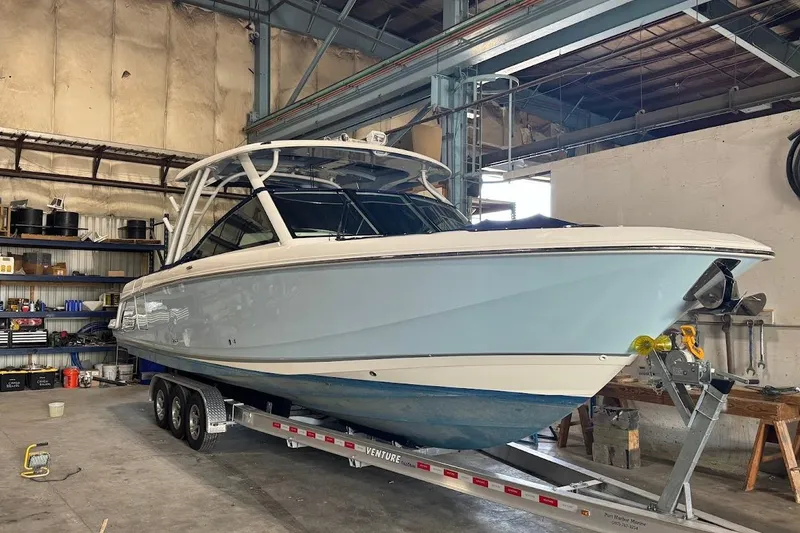 Slide: The Image of 2022 Boston Whaler 320 Vantage boat on trailer in a warehouse setting. - 5